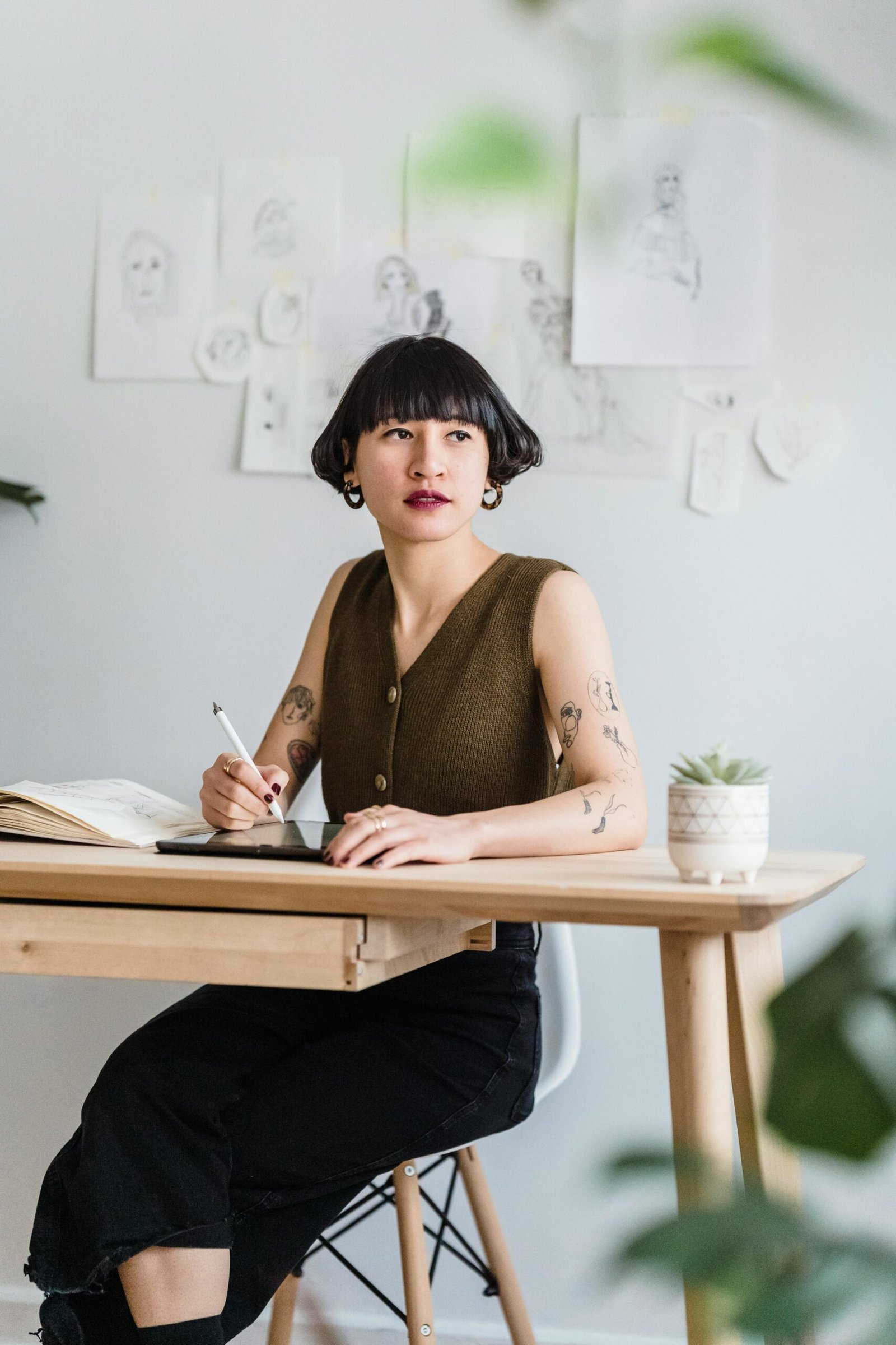 Young female designer working creatively at a desk in a modern workspace.